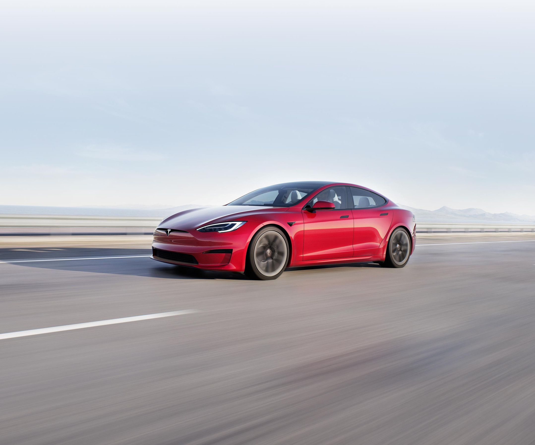 Solid black Model S accelerating on an elevated highway